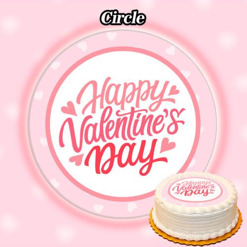 A white cake with scalloped edges is adorned with the Edible Valentine's Day Cake Topper, boasting "Happy Valentine's Day" in pink icing. It rests against a pink background featuring a prominent circular graphic that echoes the same heartfelt message at its center.