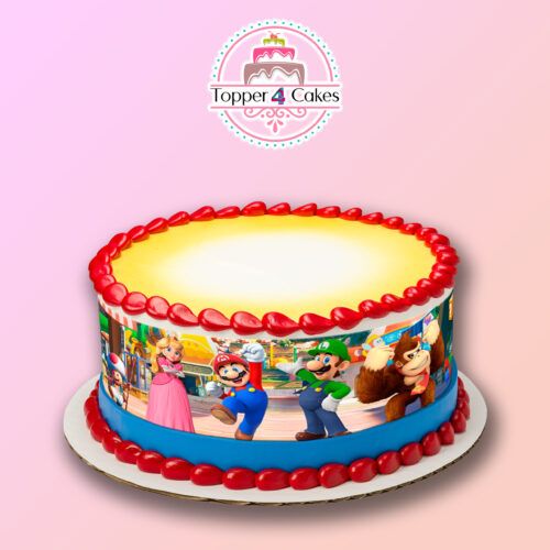 A round cake adorned with vibrant video game character decorations and red icing around the top and bottom edges rests against a gradient pink background. The logo for Topper 4 Cakes is positioned above the cake, making it an ideal complement to your Edible Drink Toppers for your next celebration.