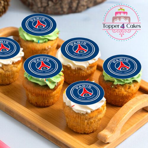 A wooden tray holds six cupcakes, each decorated with the Edible Liverpool Cupcake Topper Personalised, resembling a sports team emblem. These customized goodies are topped with green and white frosting. In the background, the Topper 4 Cakes logo featuring a cake design is visible.