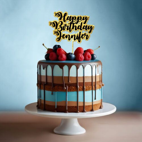 A stunning cake with chocolate drips and a Custom Double Layer Glitter Cake Topper reading Happy Birthday Jennifer sits on a white stand, beautifully adorned with raspberries, blueberries, and strawberries against a serene blue background.