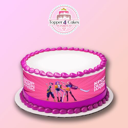 The Edible Cinnamoroll Ribbon (Copy) cake features pink icing, a Cinnamoroll ribbon, and a printed image of three animated K-pop style characters, displayed on a white plate with the Topper 4 Cakes logo against a pink gradient backdrop.