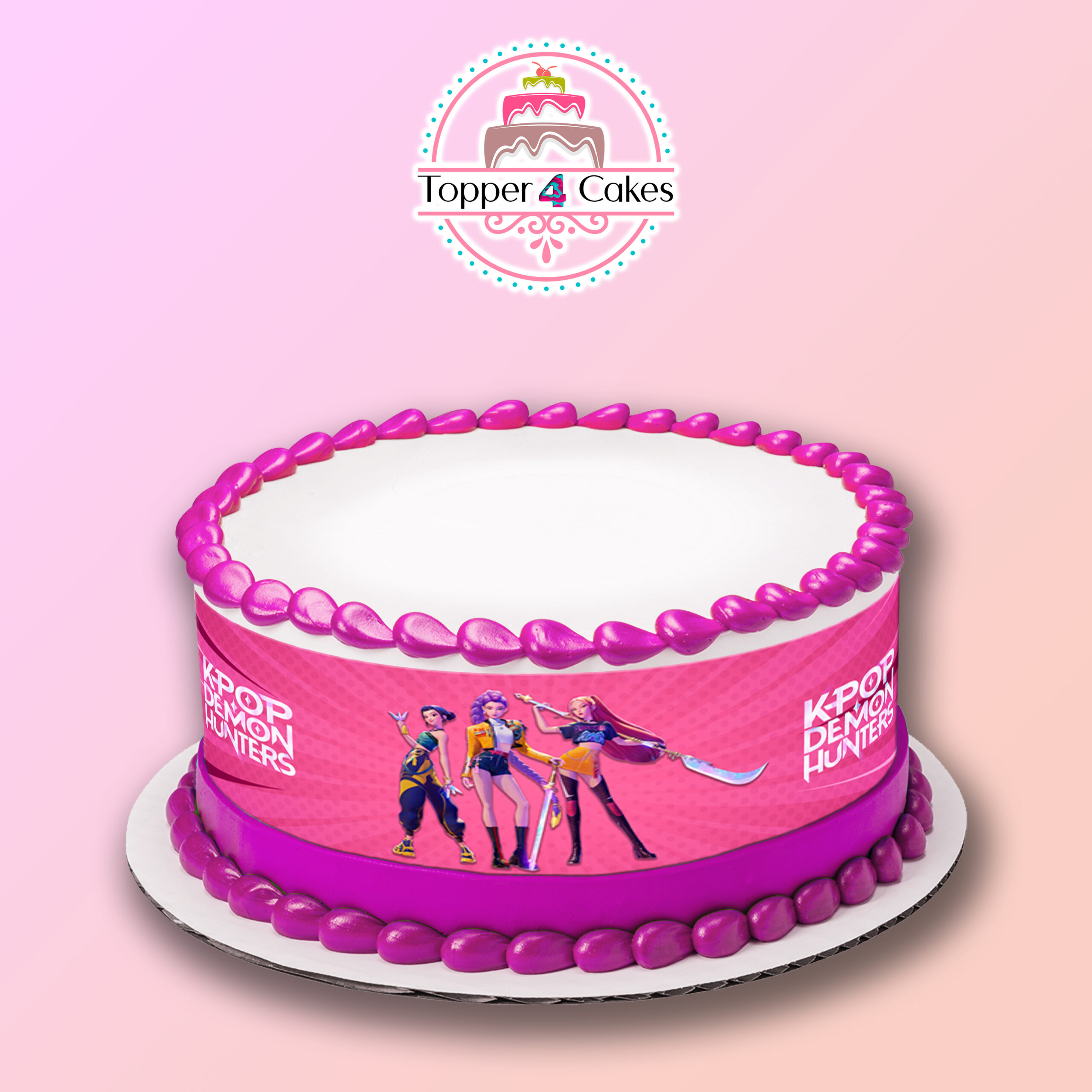 The Edible Cinnamoroll Ribbon (Copy) cake features pink icing, a Cinnamoroll ribbon, and a printed image of three animated K-pop style characters, displayed on a white plate with the Topper 4 Cakes logo against a pink gradient backdrop.