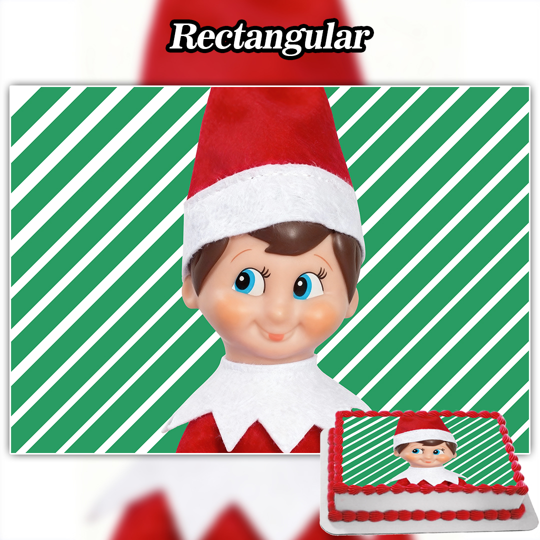 A rectangular cake with a smiling elf doll in red and white on a green striped background features the Edible Saja Boys Cake Topper (Copy) for a delightful festive touch.